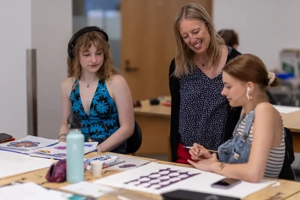 Professor and students looking at color samples