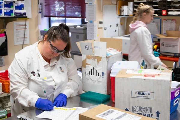 Lab technicians in white coats in the Oregon Veterinary Diagnostic Laboratory