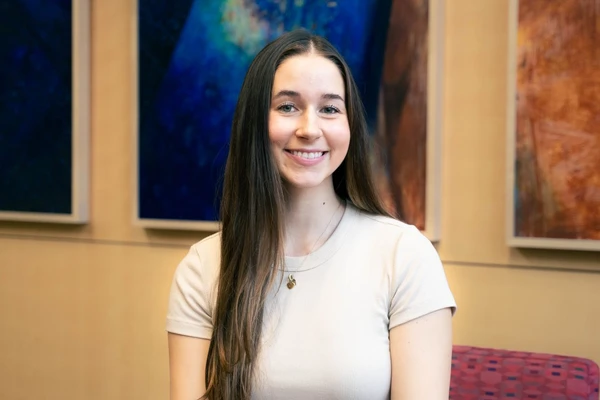 Portrait of Kennedy Duff with long brown hair and pale t-shirt. 