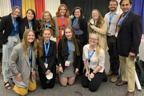 A group of students posing for a photo at an academic conference.