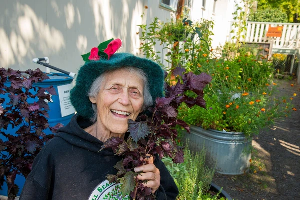 Woman in hat smiling in garden